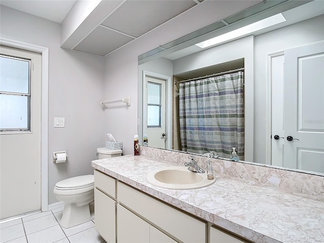 bathroom with tile patterned flooring, vanity, plenty of natural light, and toilet