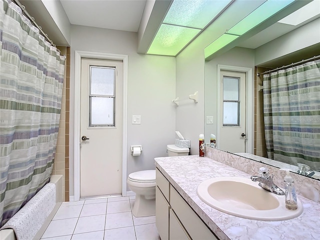 full bathroom with shower / bath combo with shower curtain, tile patterned floors, toilet, and vanity