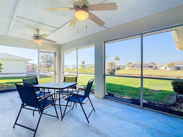 sunroom / solarium featuring ceiling fan