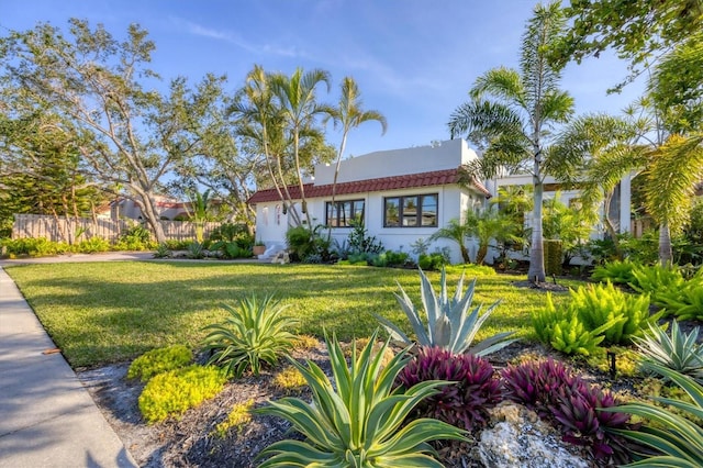 mediterranean / spanish-style home featuring a front yard