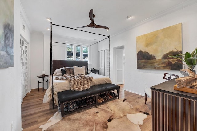 bedroom featuring hardwood / wood-style flooring, ceiling fan, ornamental molding, and a closet