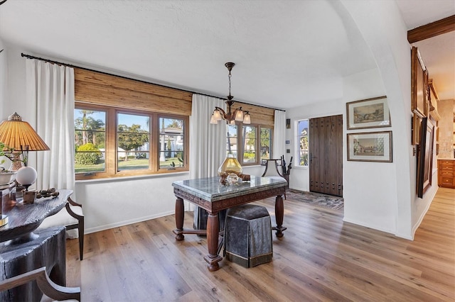 dining area with a chandelier and light hardwood / wood-style floors