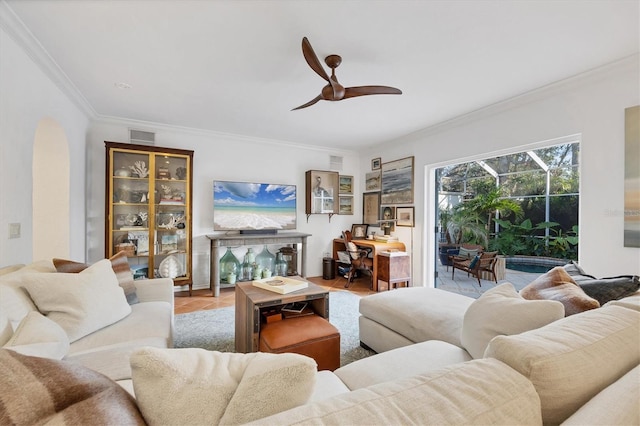 living room featuring ceiling fan and ornamental molding