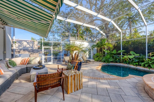 exterior space featuring outdoor lounge area, glass enclosure, and a patio area