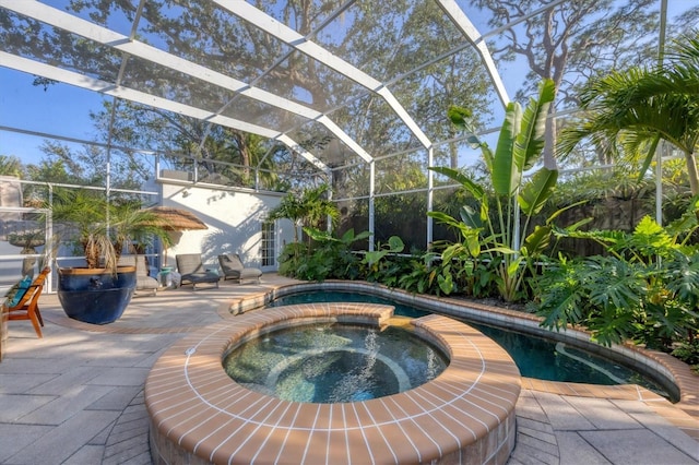 view of pool featuring an in ground hot tub, a lanai, and a patio