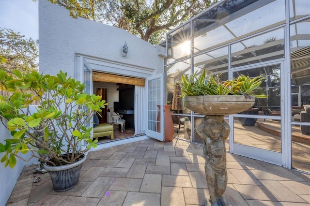 view of patio featuring glass enclosure