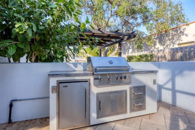 view of patio / terrace featuring area for grilling, a pergola, and grilling area