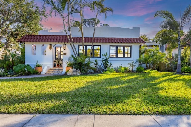 mediterranean / spanish-style home featuring a yard