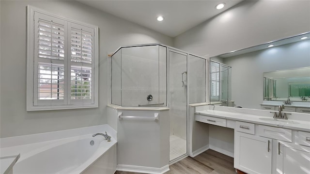 bathroom with hardwood / wood-style flooring, vanity, and independent shower and bath