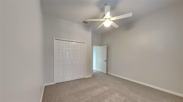 unfurnished bedroom with light carpet, ceiling fan, and a closet