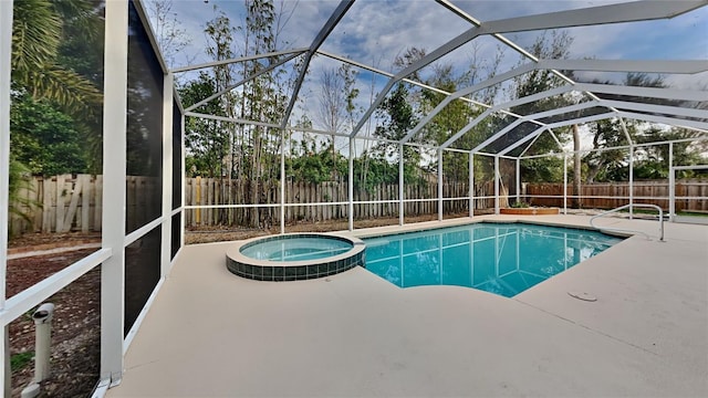 view of swimming pool with a patio area, glass enclosure, and an in ground hot tub