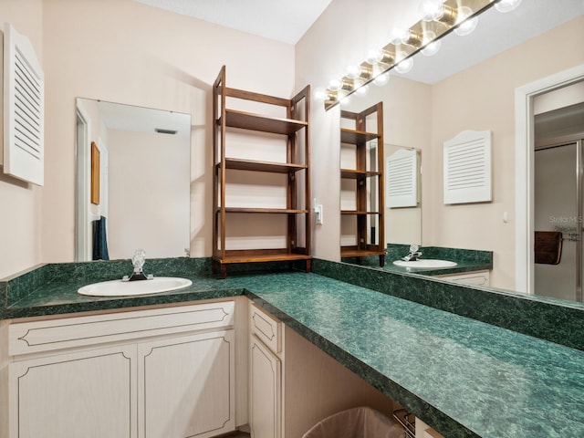 bathroom with vanity and a shower with door