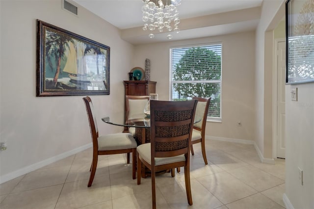 dining space with light tile patterned floors and a chandelier