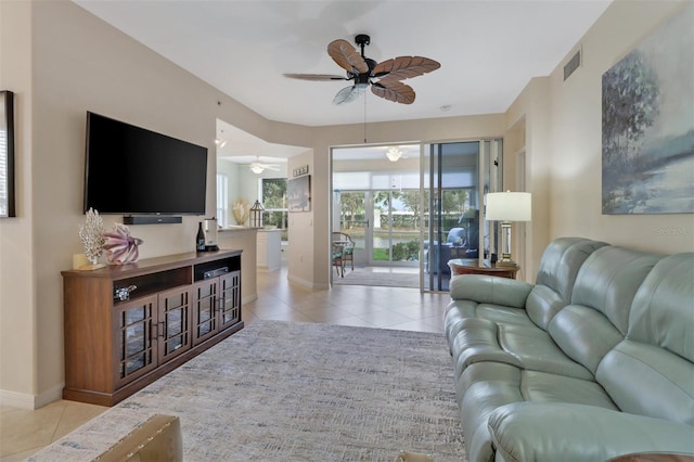 tiled living room with ceiling fan