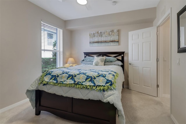 bedroom with ceiling fan and light carpet