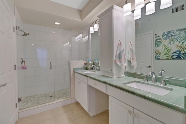 bathroom with tile patterned flooring, vanity, and an enclosed shower