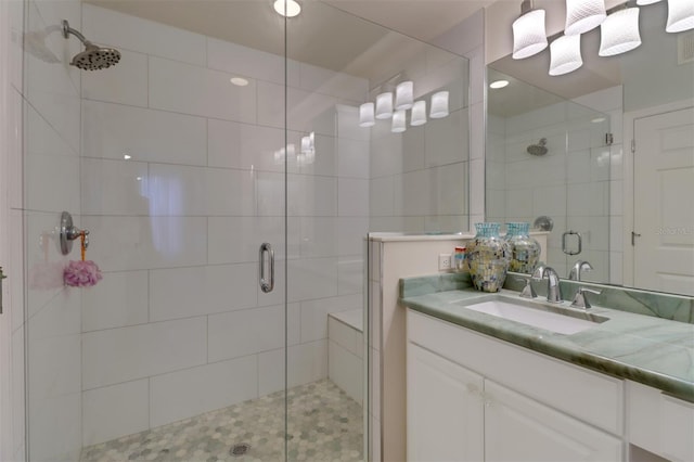 bathroom featuring vanity and a shower with door