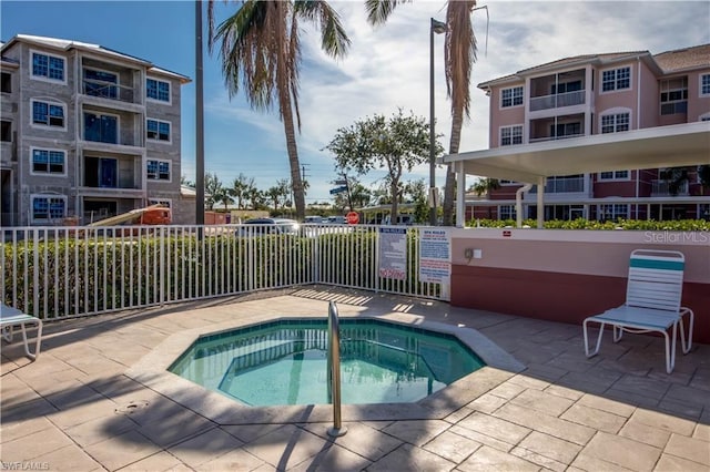 view of swimming pool with a patio area and a community hot tub