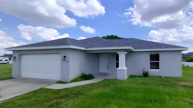 view of front of property featuring a garage and a front lawn