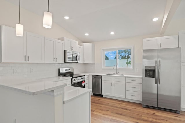 kitchen featuring white cabinetry, sink, pendant lighting, and appliances with stainless steel finishes