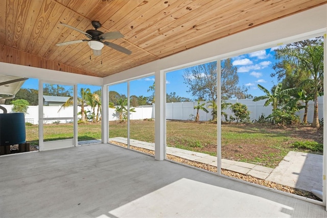 unfurnished sunroom featuring plenty of natural light, wooden ceiling, and ceiling fan