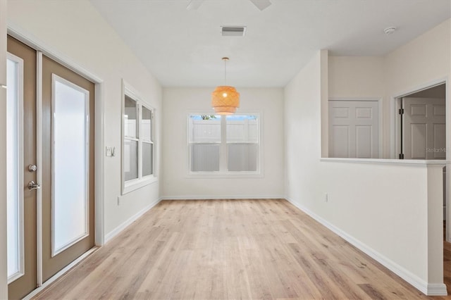 unfurnished dining area with light hardwood / wood-style flooring