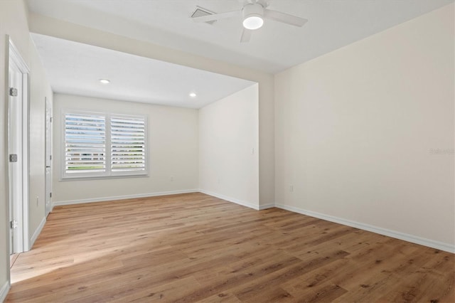 empty room featuring ceiling fan and light hardwood / wood-style floors