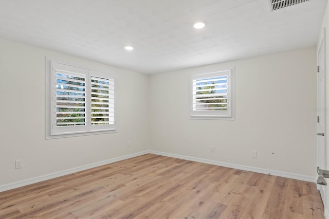 unfurnished room with light wood-type flooring