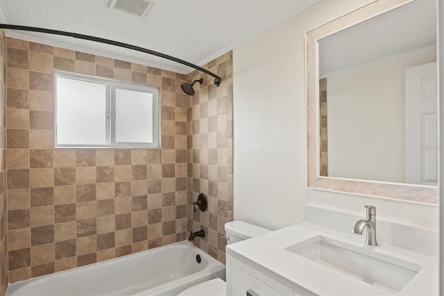 full bathroom with vanity, tiled shower / bath combo, crown molding, and toilet