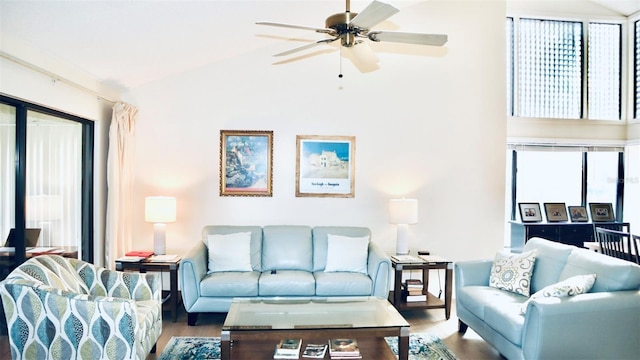 living room featuring lofted ceiling, hardwood / wood-style flooring, and ceiling fan