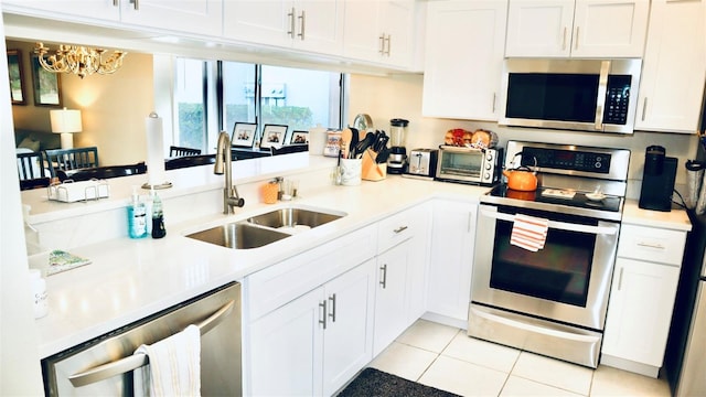 kitchen featuring white cabinetry, appliances with stainless steel finishes, and sink