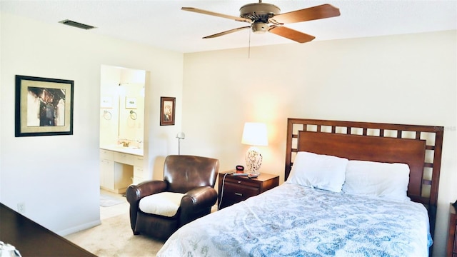 carpeted bedroom with ceiling fan and ensuite bathroom