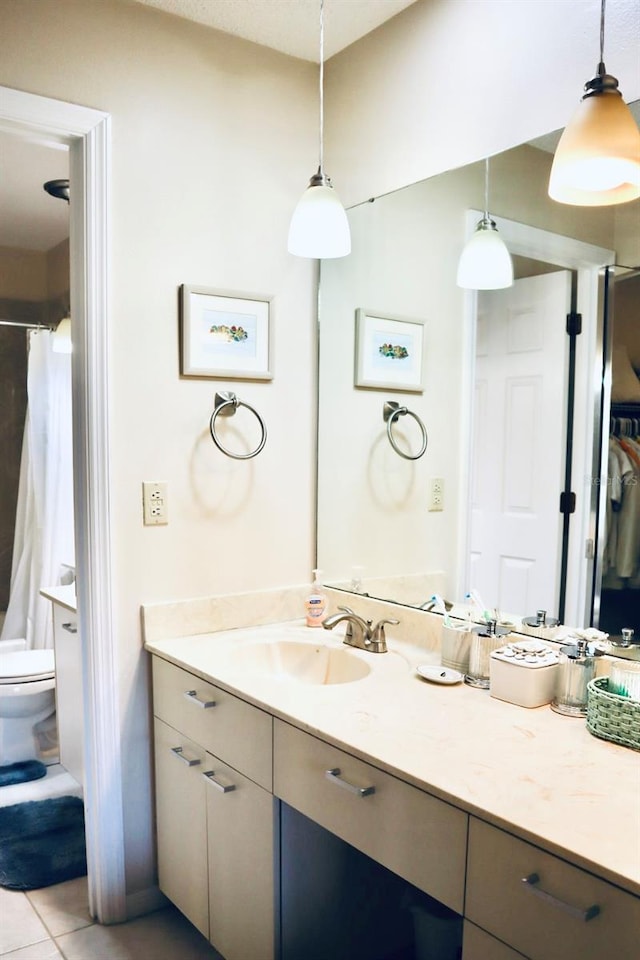 bathroom with vanity, tile patterned flooring, and toilet