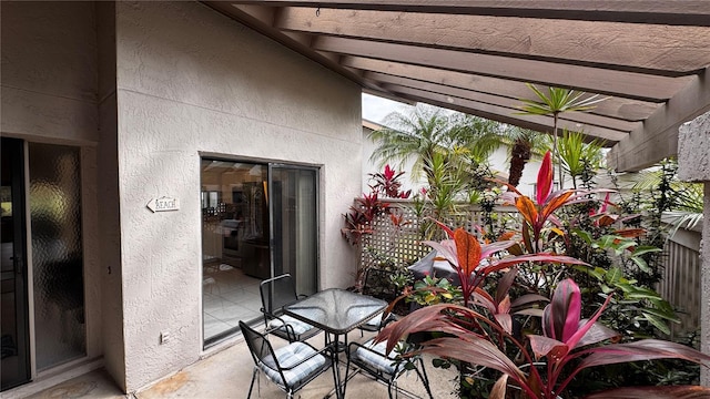 balcony featuring a pergola and a patio