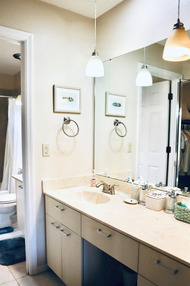 bathroom with tile patterned floors, vanity, and toilet