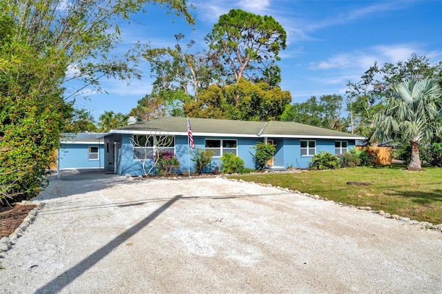 single story home featuring a front lawn