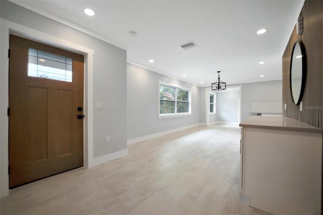 entryway featuring light hardwood / wood-style flooring and ornamental molding