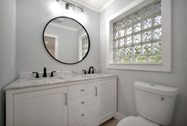 bathroom featuring vanity, ornamental molding, and toilet