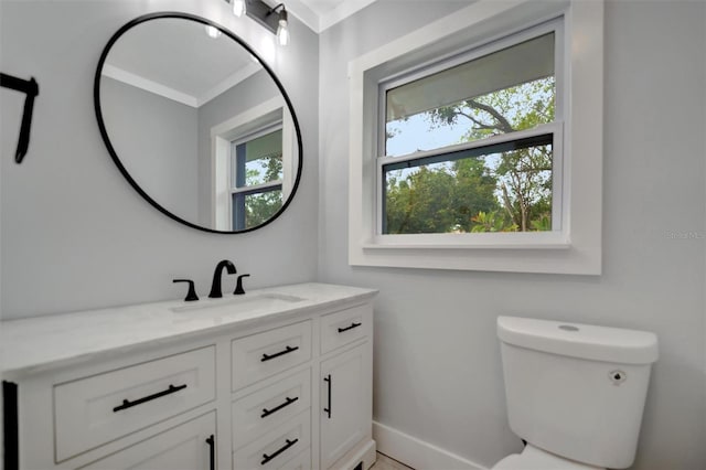 bathroom featuring vanity, crown molding, and toilet