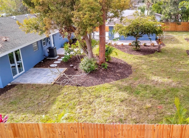 view of yard featuring central AC and a patio area