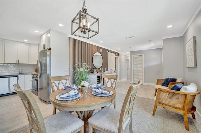 dining area with recessed lighting, a chandelier, baseboards, and crown molding