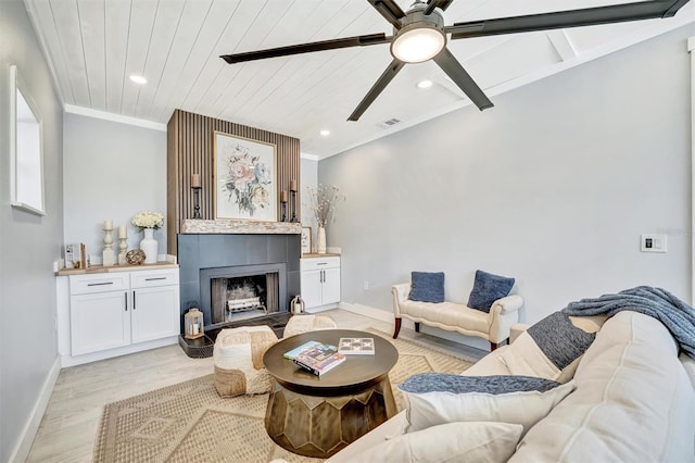 living room with baseboards, ceiling fan, recessed lighting, light wood-type flooring, and a fireplace