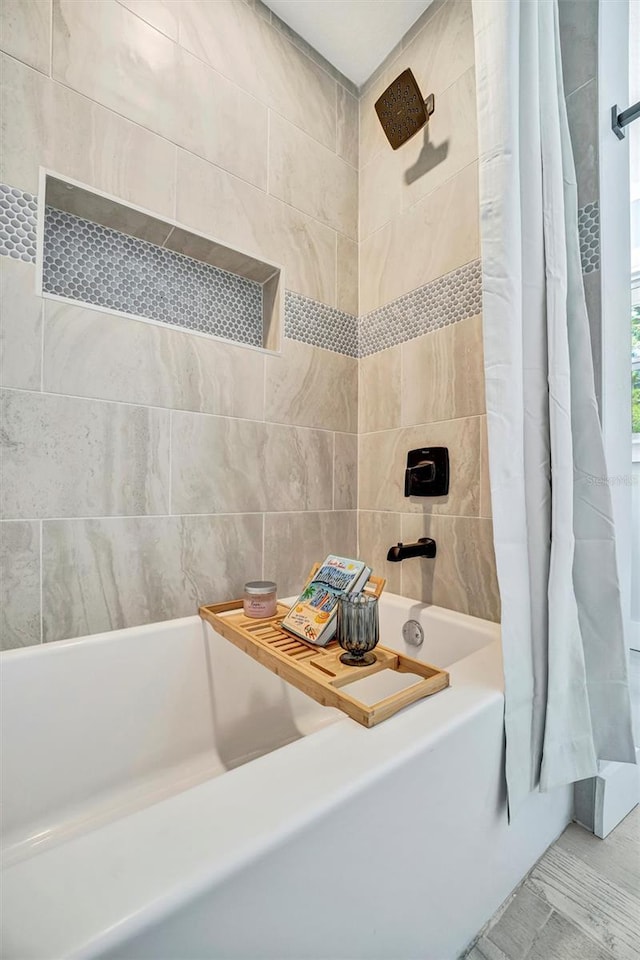 bathroom with shower / bathtub combination with curtain and tile walls