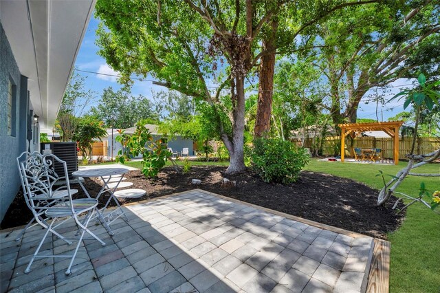 view of patio / terrace featuring central AC unit and a pergola
