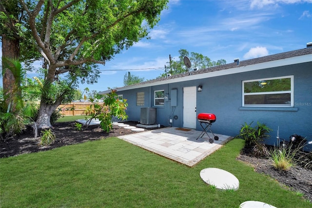 rear view of property featuring a patio area, stucco siding, and central AC unit