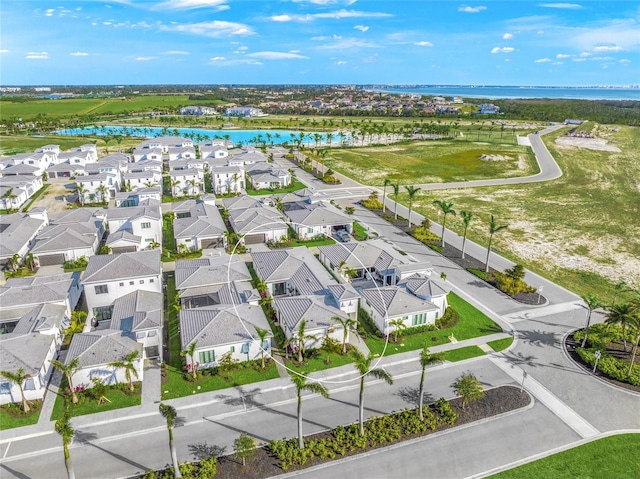 drone / aerial view with a residential view and a water view