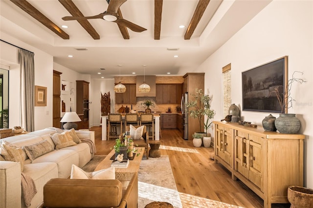 living room featuring recessed lighting, beam ceiling, ceiling fan, and light wood finished floors