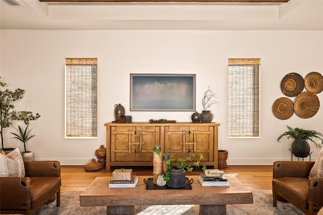 sitting room featuring baseboards, visible vents, and light wood finished floors