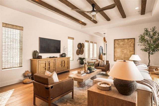 living room featuring baseboards, a ceiling fan, light wood-style floors, beam ceiling, and recessed lighting