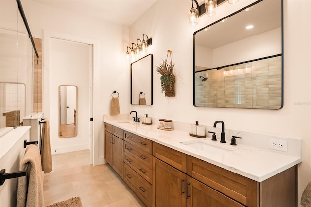 full bath featuring a sink, a shower stall, and double vanity